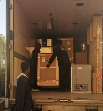 Family Movers Ethio team unloading boxes from their truck.