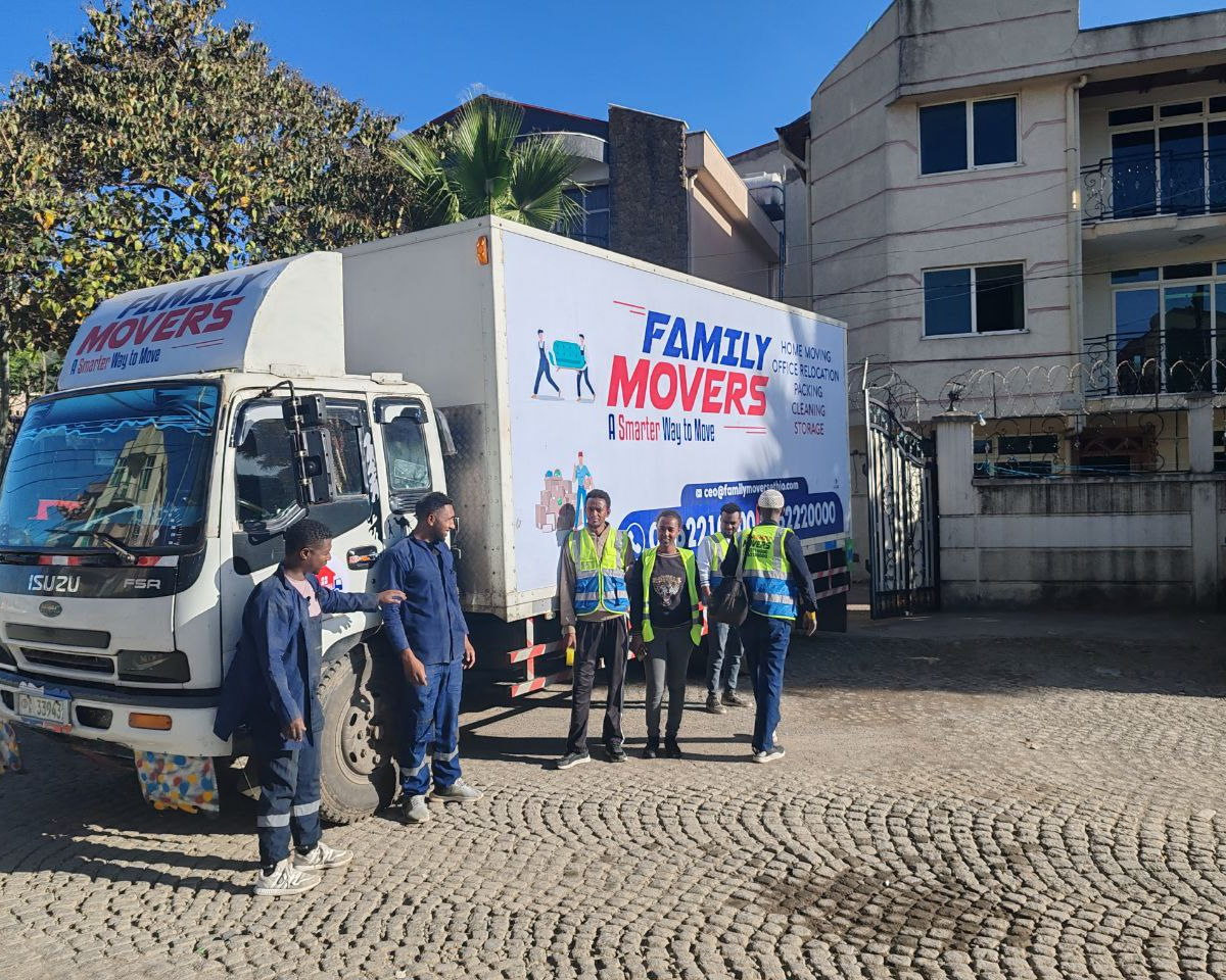 Family Movers Ethio branded moving truck parked on a residential street in Addis Ababa, displaying home moving, office relocation, packing, cleaning, and storage services